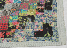 This vintage patchwork quilt was crafted in North America during the middle of the 20th century.


It features patch-worked squares of various fabric in rows of serrated stripes organized on the diagonal. Many of the squares feature there own detailed patterning which adds interest and touch of fun! Much of the stitching has been completed by hand included large visible running stitches in black giving the piece a kantha-like feel.