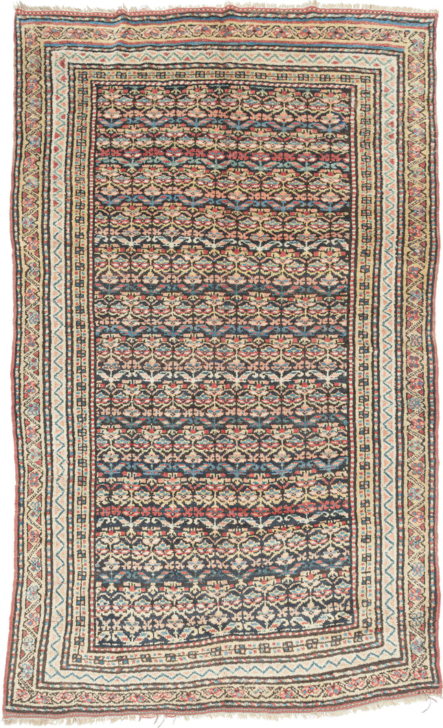 Quchan KURD It features a fine and densely woven lattice of repeating floral motifs in various blues, red, yellow, green, peach, brown and ivory set against an indigo ground. The interconnected patterning and consistent use of color and spacing create a mesmerizing rhythm. Nicely framed by a series of larger borders of shapes and rosettes and thinner simple candy cane stripes in an array of tones