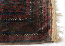  Timuri Baluch was handwoven during the second quarter of the 20th century in Western Afghanistan.

It features a lattice pattern of stepped diamonds and serrated polygons. With lush deep blue and red wool with a dark but lustrous complexion. The addition of a dark brown which has oxidized naturally sculpts the pattern and gives the shapes the feeling of floating in space. Bright speckles of white cotton have been woven around the main border adding a subtle touch of electricity. weft float