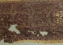 This Coptic textile was woven in Egypt or the Levant in the 4th - 5th century AD.&nbsp;

This large fragment has a highly intricate design rendered in the two classic tones associated with Coptic textiles, purplish brown and wheat. It features a central band of octagons primarily filled with lion-like figures except for one central octagon filled with two figures with extraterrestrial-like features. The central is flanked by two borders full of overlapping and intersecting anthropomorphic figures.