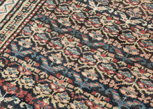 Quchan KURD It features a fine and densely woven lattice of repeating floral motifs in various blues, red, yellow, green, peach, brown and ivory set against an indigo ground. The interconnected patterning and consistent use of color and spacing create a mesmerizing rhythm. Nicely framed by a series of larger borders of shapes and rosettes and thinner simple candy cane stripes in an array of tones