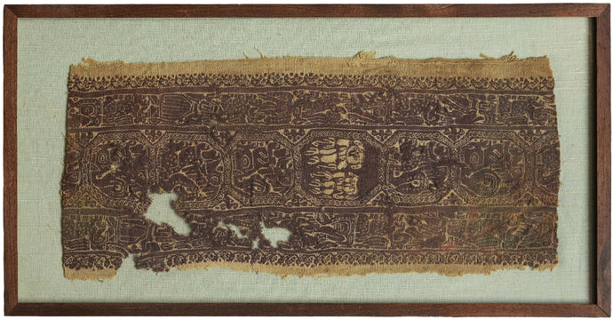 This Coptic textile was woven in Egypt or the Levant in the 4th - 5th century AD. 

This large fragment has a highly intricate design rendered in the two classic tones associated with Coptic textiles, purplish brown and wheat. It features a central band of octagons primarily filled with lion-like figures except for one central octagon filled with two figures with extraterrestrial-like features. The central is flanked by two borders full of overlapping and intersecting anthropomorphic figures.