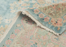 This Kerman rug handwoven during the second quarter of the 20th century.


It features a central medallion floating above an open turquoise ground and framed by a large and elegant border. The medallion and border are both composed of beautifully detailed floral sprays in pastel pinks, reds, seafoam green, copper, and gold and khaki.&nbsp;