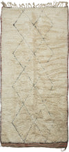 This Beni Ourain rug was woven during the middle of 20th century in the Middle Atlas Mountains of Morocco.

It features a central column of black latticed diamonds on a creamy white ground.&nbsp; Red and brown stripes can be found around the perimeter, most prominently in the striped kilim end borders. Good quality wool in a large format. Often imititated this is the real deal Moroccan shag that Frank Lloyd Wright referred to as "White Giants"&nbsp;