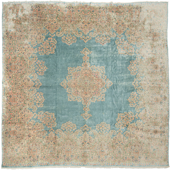 This Kerman rug handwoven during the second quarter of the 20th century.


It features a central medallion floating above an open turquoise ground and framed by a large and elegant border. The medallion and border are both composed of beautifully detailed floral sprays in pastel pinks, reds, seafoam green, copper, and gold and khaki. 