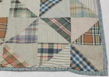 This vintage patchwork quilt was crafted in North America during the middle of the 20th century.


It features patch-worked grid composed of squares. Each square is formed of well balanced triangles of either colorful flannel patterns or more open dotted and striped cream ground patterning. The squares have been pieced together wondefully and the composition can be read many different ways that is accentuated by its perfectly square dimensions.