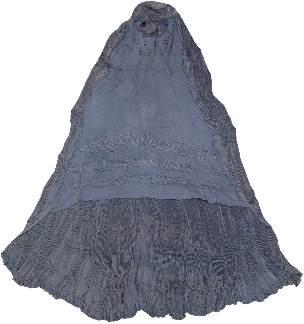 This Burqa was crafted in Afghanistan during the late 20th century. 

A burqa is a full-body garment that covers a woman's face and body. This burqa is made of periwinkle blue fabric with crimping around the back and floral embroidery below mesh opening for the eyes.

It is in good condition with small patches and some sun fading.

Special Provenance: Formerly in the collection of Yosi Barzilai Sarajo