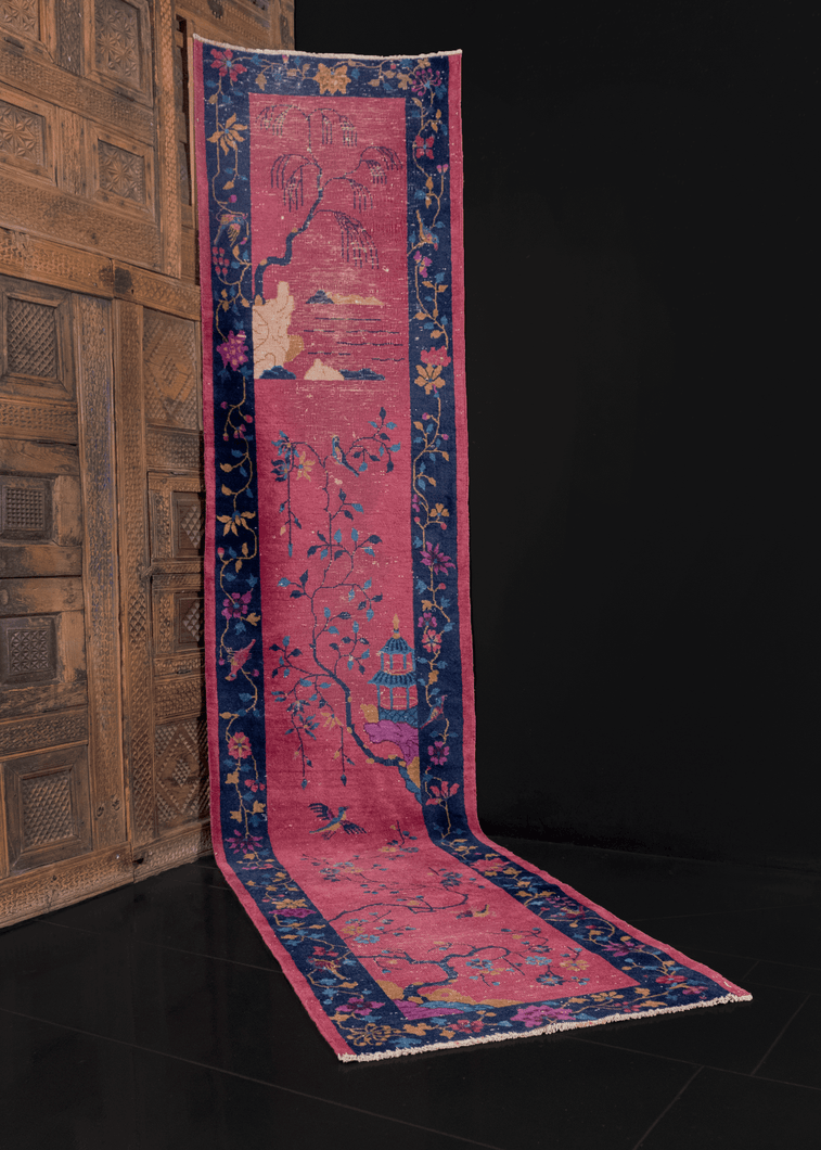 chinese deco runner with a purple field and tree design in the centre, floral meander for the border. in good condition, signs of wear consistent with age. 