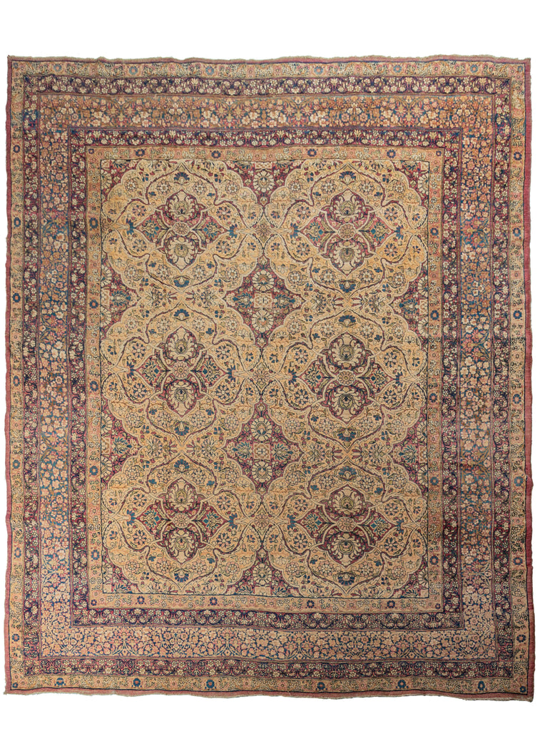 Antique Persian Lavar Kerman carpet featuring a curvilinear floral design with six scalloped medallions and is finely woven in golden yellow and wine purple. The design plays with positive and negative space in a sophisticated and subtle manner. The five borders are just as elaborately patterned as the main field, continuing the curvilinear floral motif. They are composed of varied sprigs and meanders and show off the artful use of indigo blue for the details.   