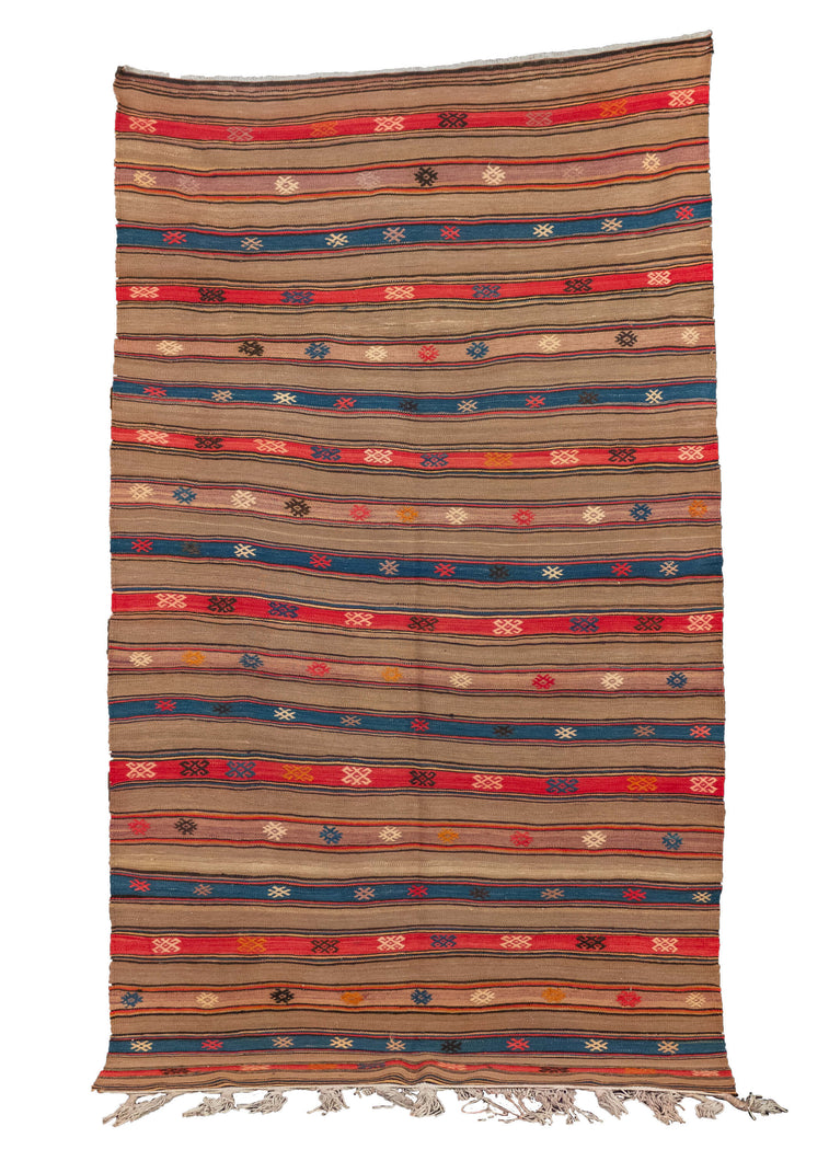 Vintage Turkish kilim, featuring a striped design with a taupe base and bright blues and reds as accent colors. The striped design is complemented by symbols and shapes throughout. In very good condition, signs of wear consistent with age.