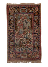 Small pictorial rug handwoven in India, featuring a variety of animals in a forest setting, and a rider on horseback. In excellent condition, signs of wear consistent with age. 