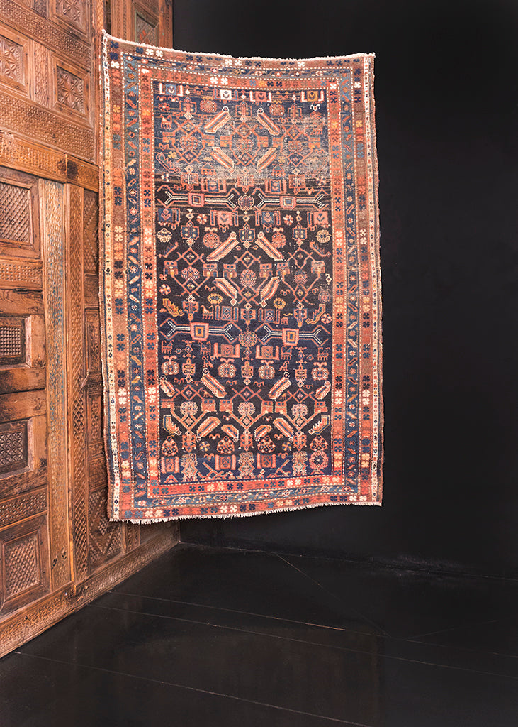 Bidjar rug handwoven second quarter of the 20th century in Northwest Iran. Deep blue, Surma, field with shades of pink, yellow, and white. 