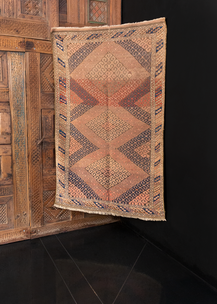 Baluch rug handwoven in Western Afghanistan during second quarter of 20th century. Soft palette of pinks, purples and browns in a diamond hook pattern characteristic of the Mashwani tribe. 