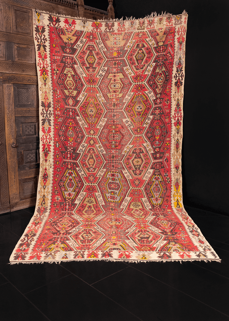 Reyhanli kilim handwoven in Southeast Turkey during second quarter of 20th century. Constructed in two parts and joined in the middle. Abstract geometric pattern in red, brown, blue and yellow. 