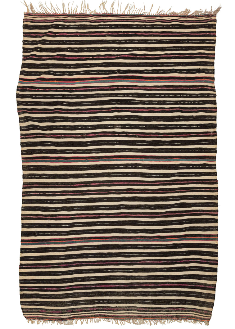 This Midcentury Moroccan Shawl is very finely woven of soft wool and features horizontal bands in black, white, and purple with moments of colorful turquoise and creamsicle. Other those few unadorned colorful moments all the other stripes feature a black and white chain stitch embossed through their center.