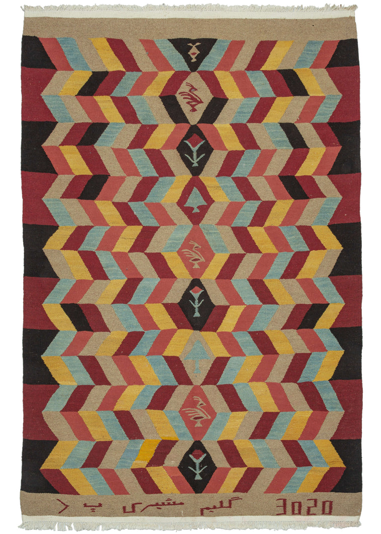 Signed NW Persian Bidjar kilim featuring a geometric design radiating out from the central diamond column. Within each diamond is a rooster, a calice flower, or a tree. The colors utilized are light blue, yellow, peach, red, tan, and black. The tan skirt border has an inscription on the bottom which reads: 