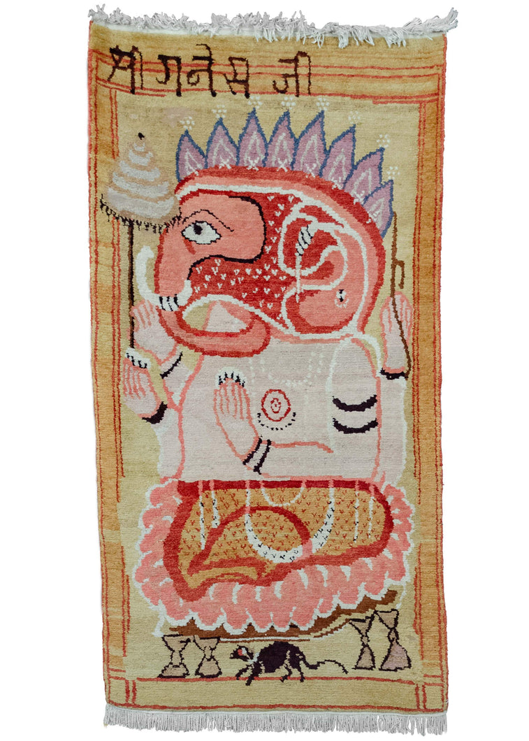 Pictorial rug handwoven in Nepal during third quarter of 20th century by Tibetan weavers. Features Ganesh with a bright palette of yellow, pink, red and purple. 